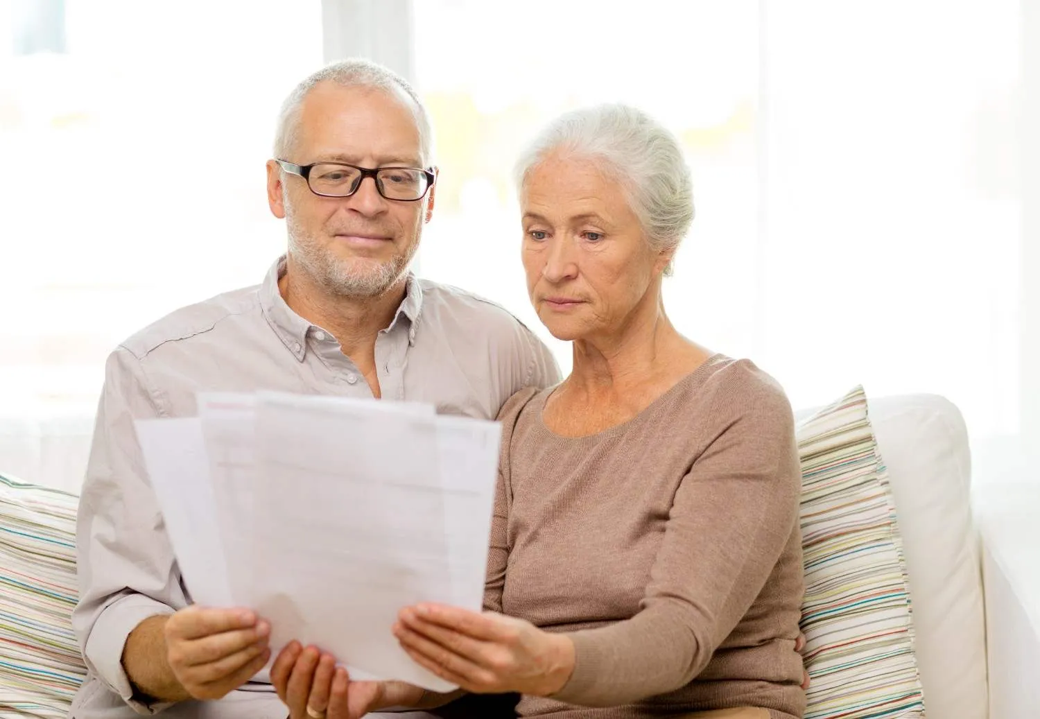 An older couple going through a set of plan letters together